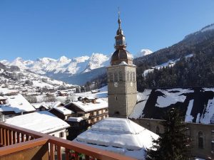 View to snowy mountains from balcony in ski resort